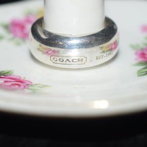 Coach sterling silver ring in a size 9. With coach brown dust bag.